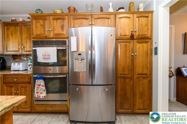 a kitchen with stainless steel appliances granite countertop a sink and cabinets