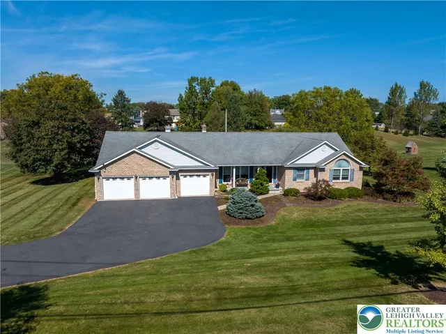 a kitchen with stainless steel appliances granite countertop a refrigerator a stove and a sink with wooden cabinets