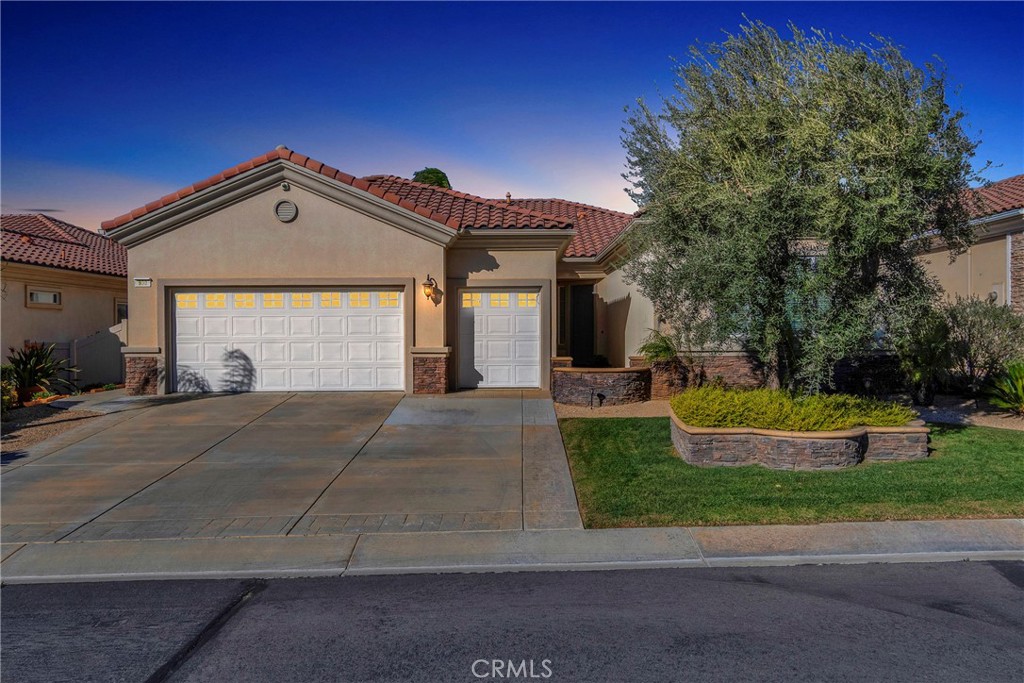 a front view of a house with a yard and garage