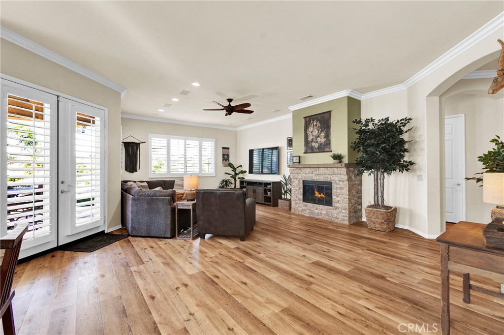 930 Gleneagles Road Beaumont, CA 92223 - Photo 11 of 40 a living room with furniture a fireplace a flat screen tv and a large window