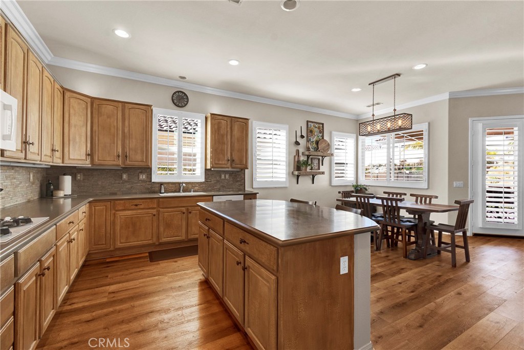 930 Gleneagles Road Beaumont, CA 92223 - Photo 15 of 40 a kitchen with stainless steel appliances granite countertop a sink stove and wooden cabinets