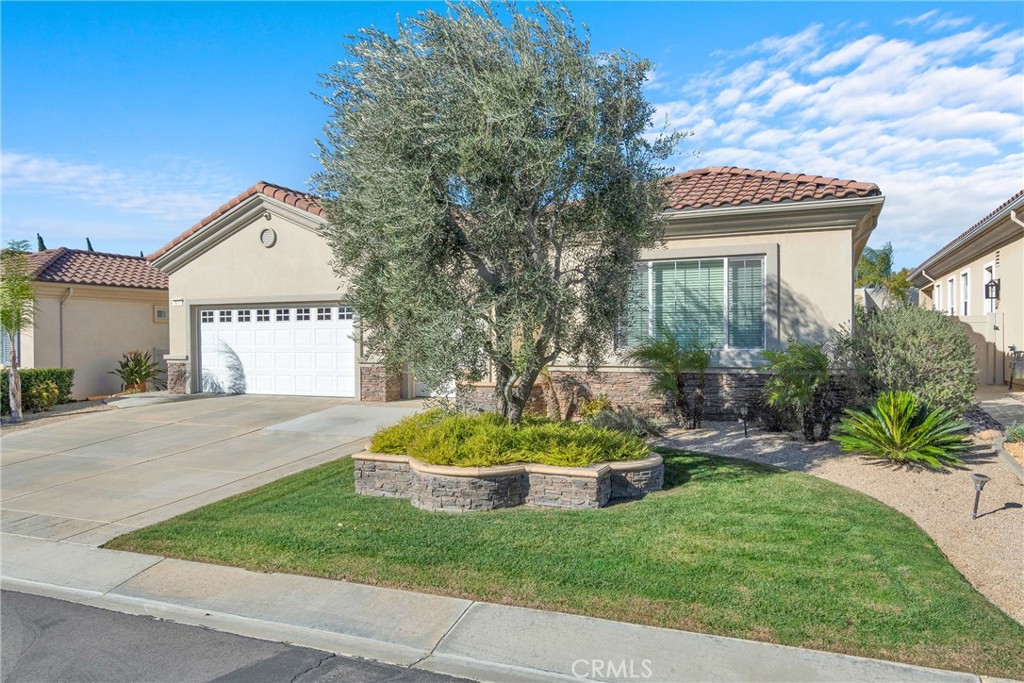 930 Gleneagles Road Beaumont, CA 92223 - Photo 2 of 40 a front view of a house with a yard garage and outdoor seating
