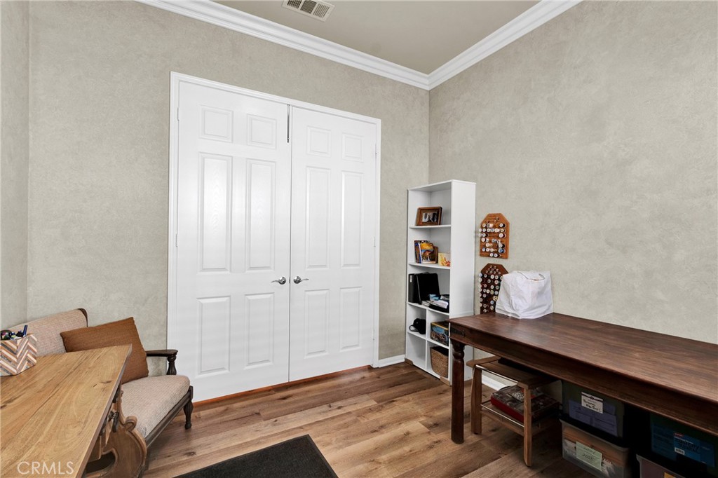 930 Gleneagles Road Beaumont, CA 92223 - Photo 23 of 40 a workspace with furniture and wooden floor