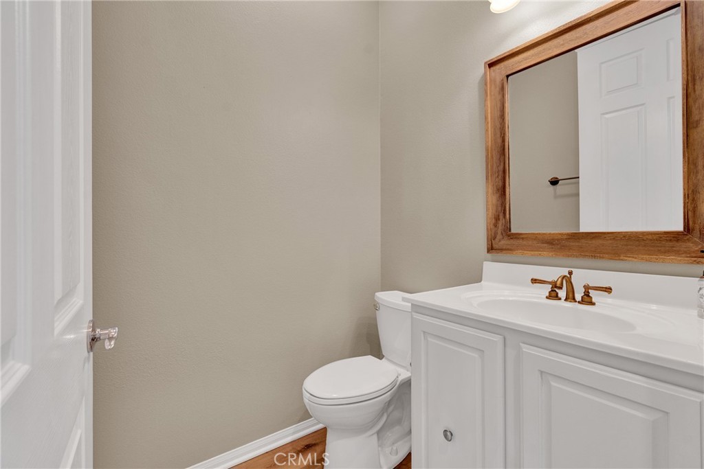 930 Gleneagles Road Beaumont, CA 92223 - Photo 25 of 40 a bathroom with a sink toilet and mirror