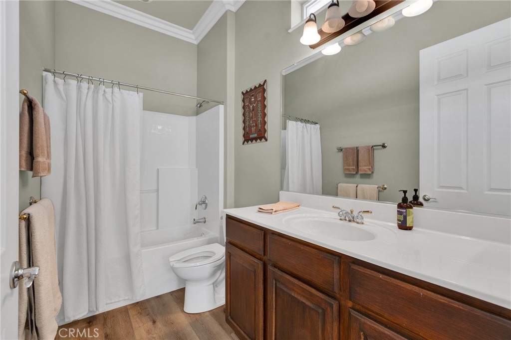 930 Gleneagles Road Beaumont, CA 92223 - Photo 29 of 40 a bathroom with a double vanity sink toilet and shower