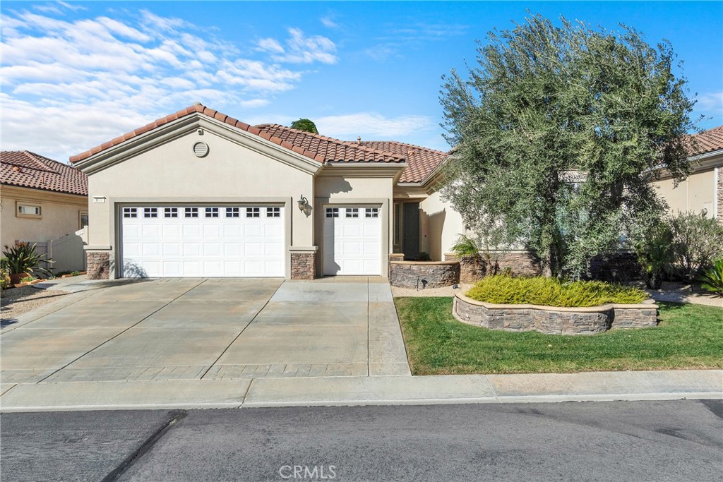 930 Gleneagles Road Beaumont, CA 92223 - Photo 35 of 40 a view of the house with a yard and potted plants