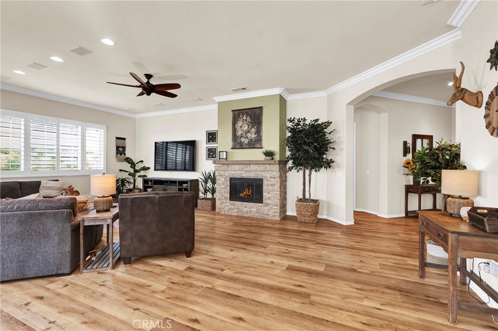 930 Gleneagles Road Beaumont, CA 92223 - Photo 10 of 40 a living room with furniture a fireplace and a flat screen tv