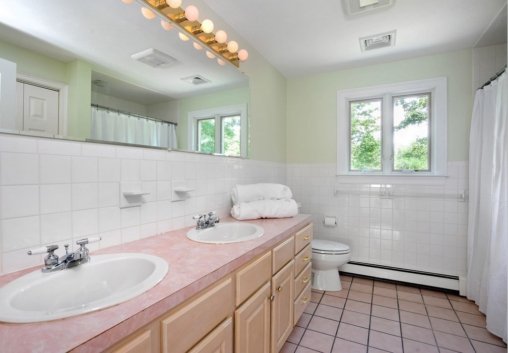 40 Upland Road Duxbury, MA 02332 - Photo 23 of 38 a bathroom with a sink toilet and window