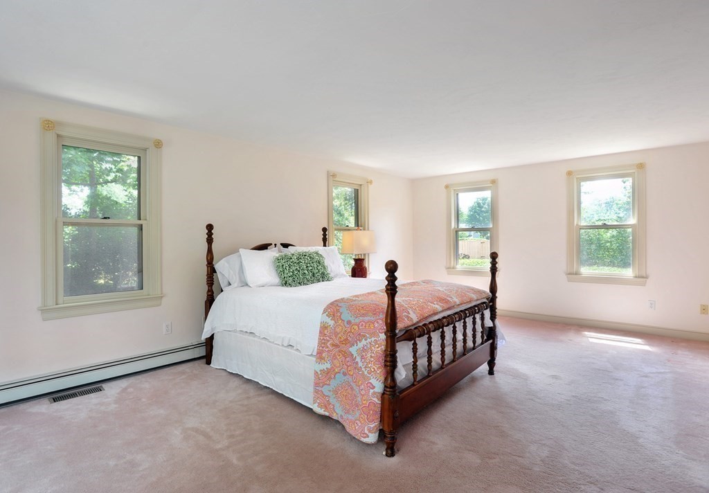 40 Upland Road Duxbury, MA 02332 - Photo 25 of 38 a spacious bedroom with a bed a window and potted plant on the dresser
