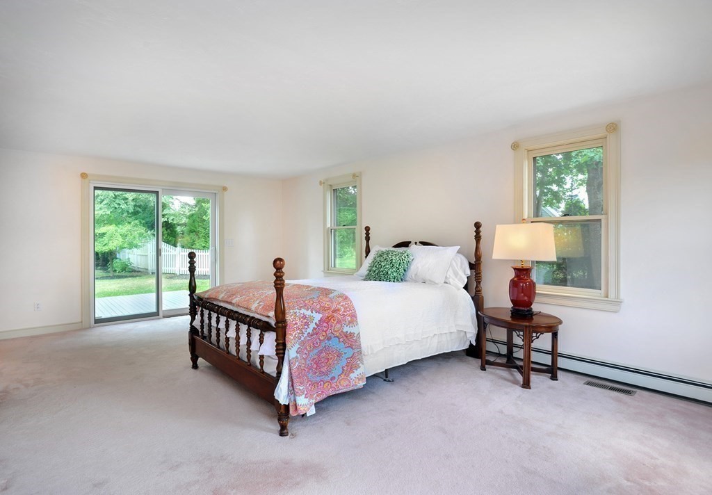 40 Upland Road Duxbury, MA 02332 - Photo 26 of 38 a bed room with a bed and a lamp
