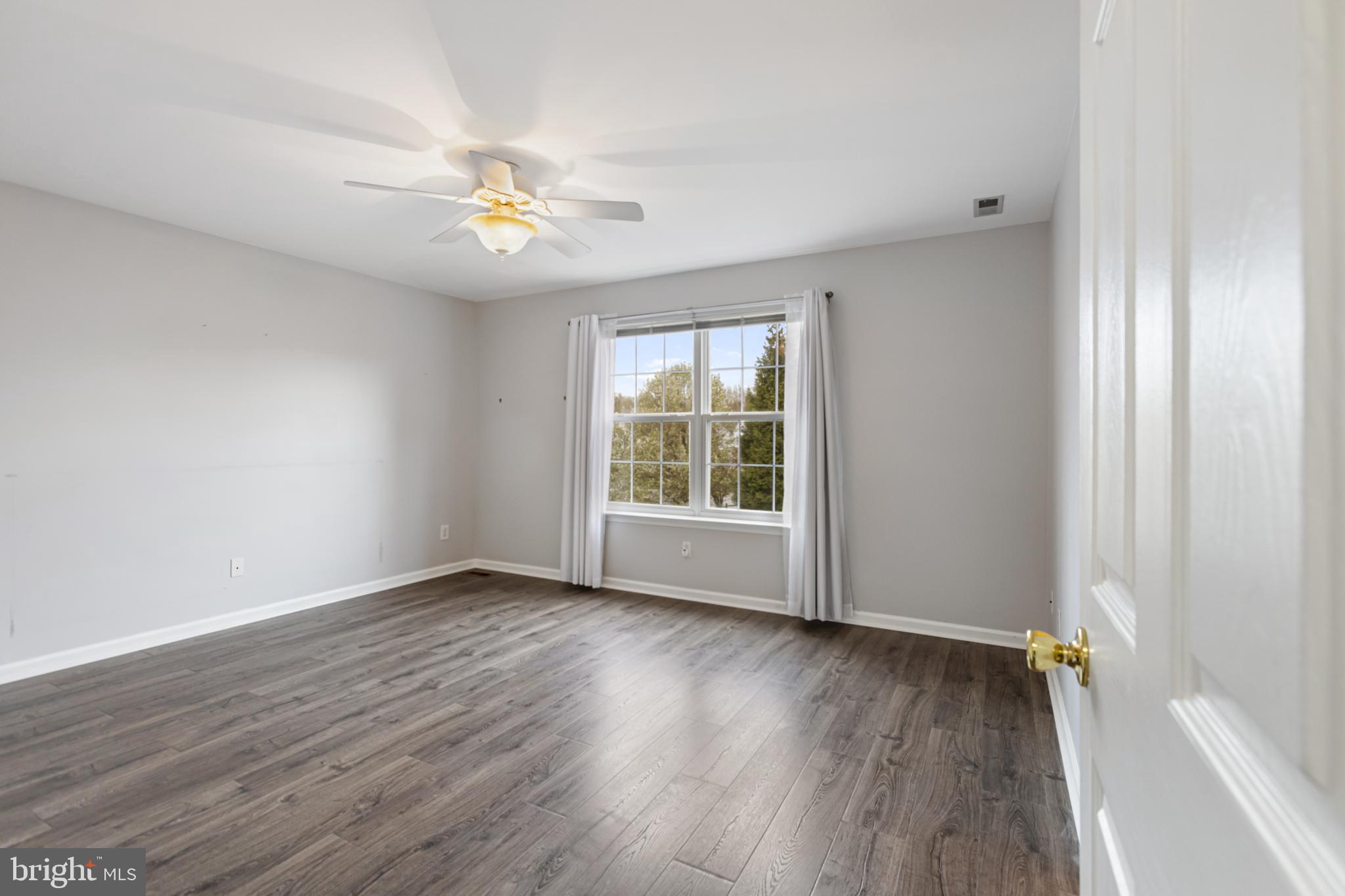 2 Kerrin Road Bear, DE 19701 - Photo 13 of 29 a view of an empty room with a window and wooden floor