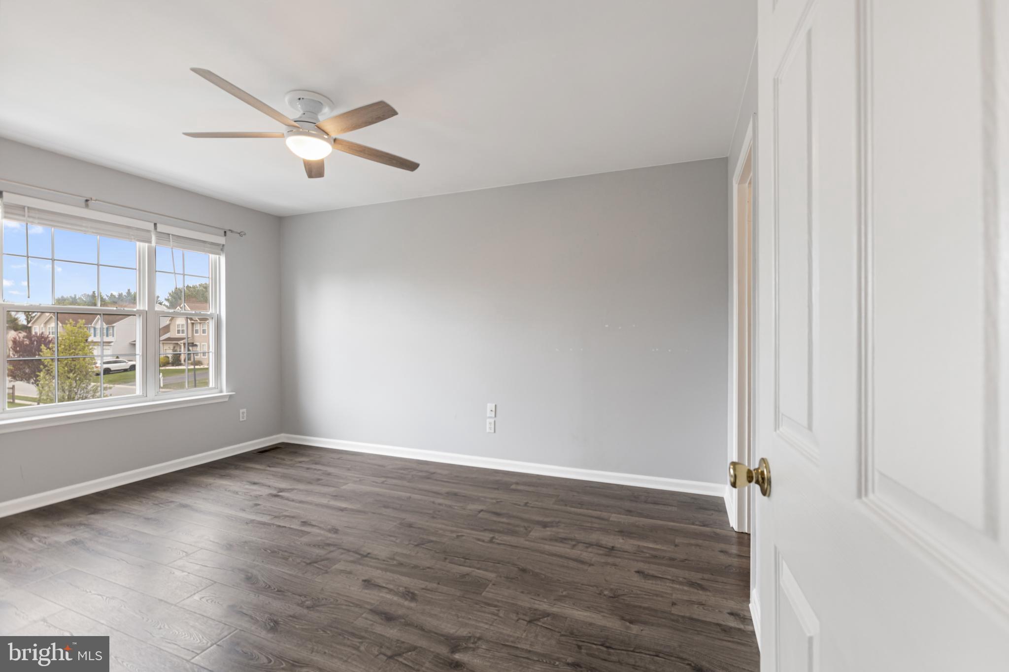 2 Kerrin Road Bear, DE 19701 - Photo 20 of 29 an empty room with wooden floor fan and windows