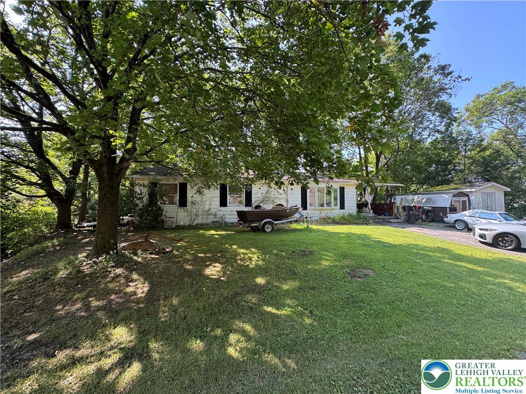 211 Fireline Road Bowmanstown, PA 18071 - Photo 2 of 4 a front view of a house with a garden