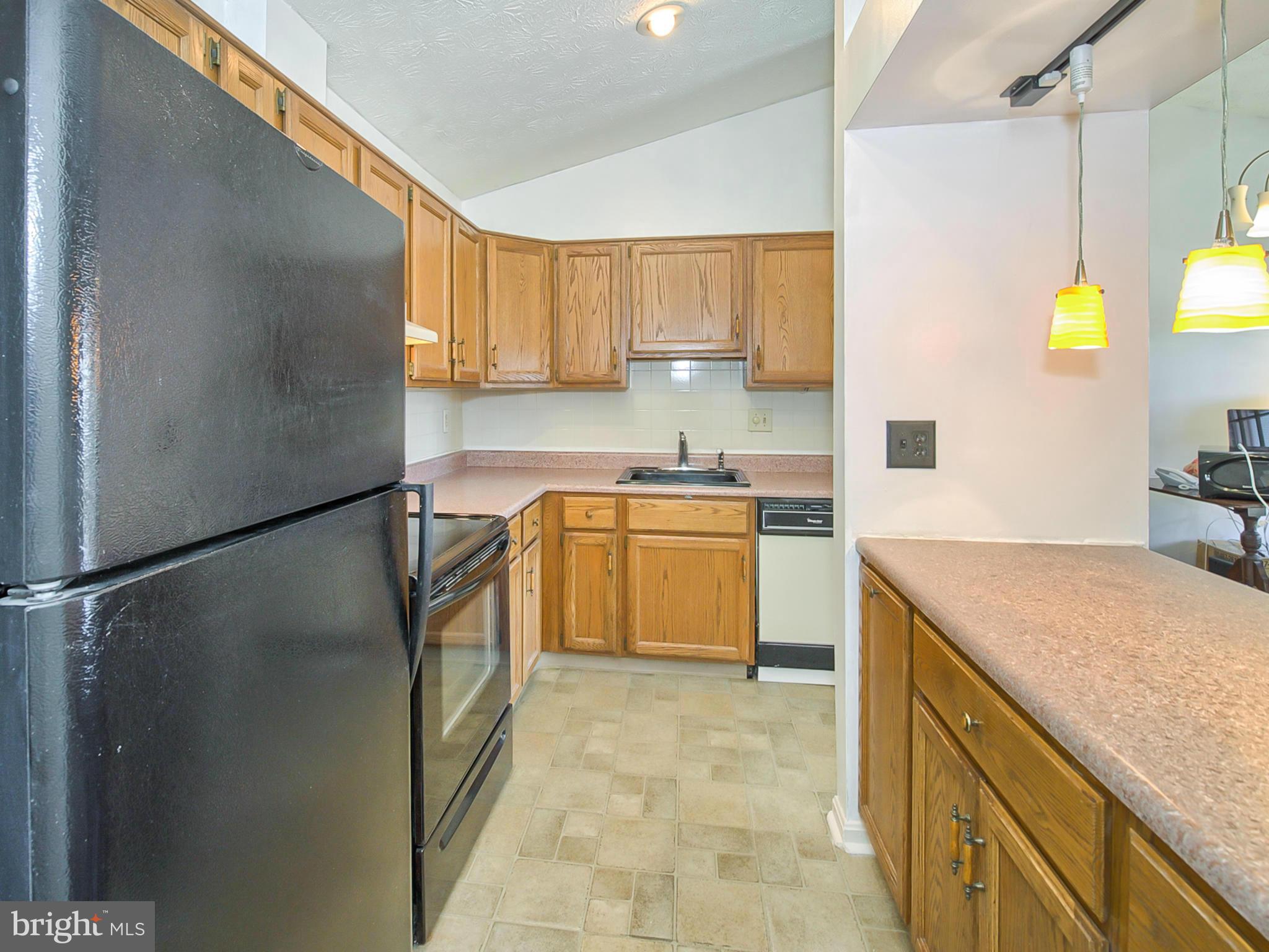 2137 Wainwright Court, Unit 2B Frederick, MD 21702 - Photo 12 of 30 a kitchen with a sink refrigerator and cabinets