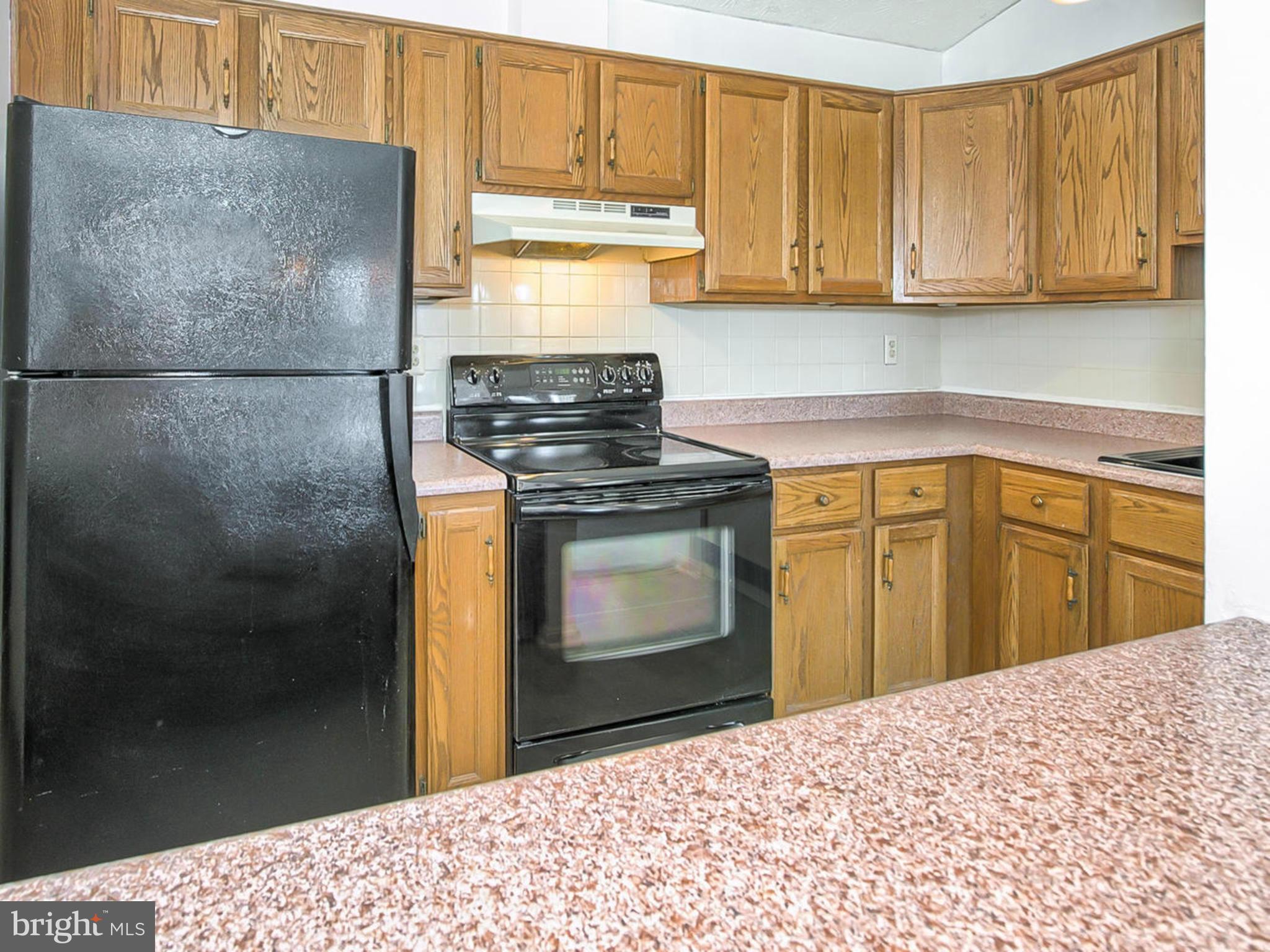 2137 Wainwright Court, Unit 2B Frederick, MD 21702 - Photo 13 of 30 a kitchen with a stove and a refrigerator