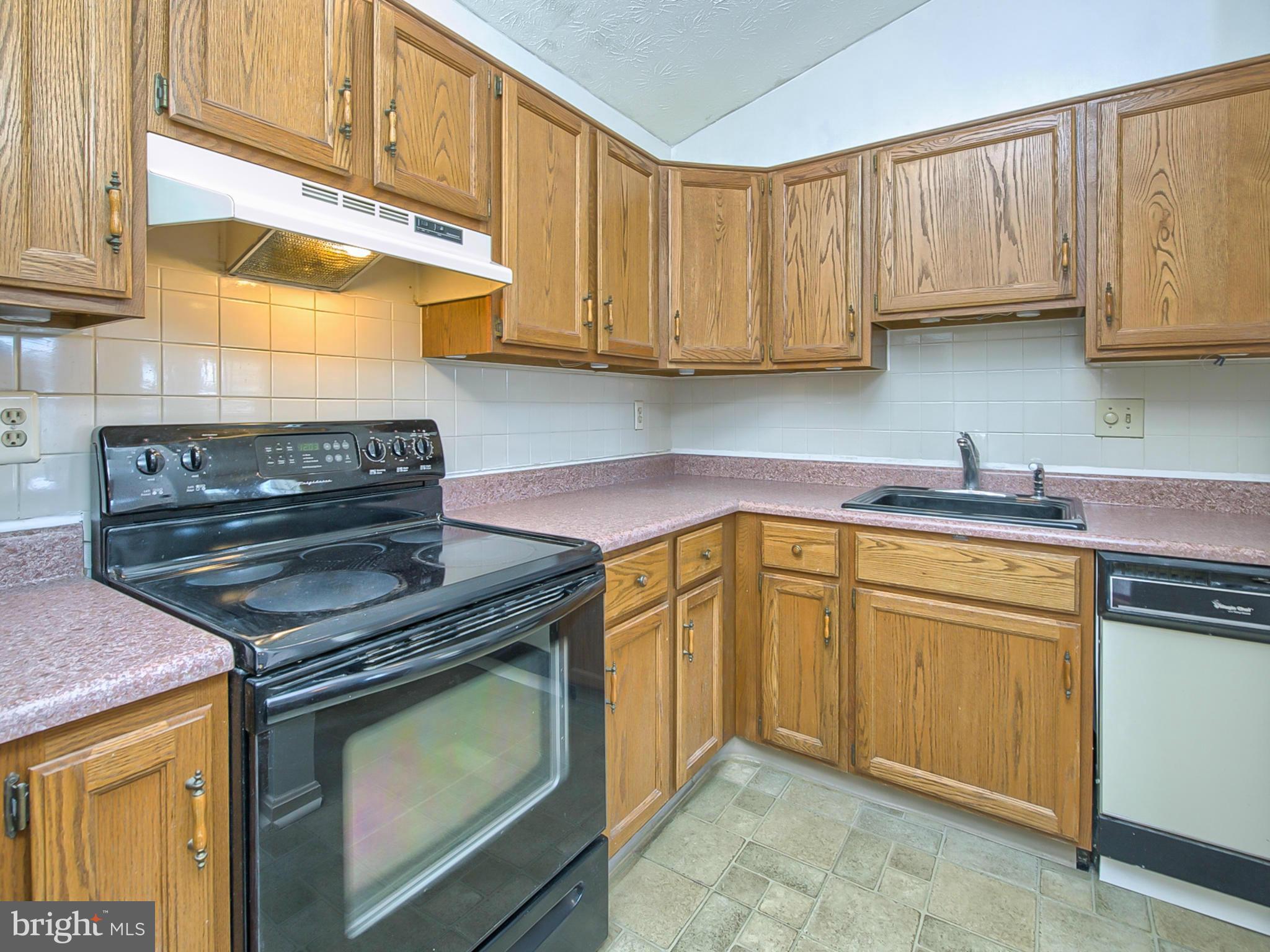 2137 Wainwright Court, Unit 2B Frederick, MD 21702 - Photo 14 of 30 a kitchen with stainless steel appliances granite countertop a stove a sink and a microwave