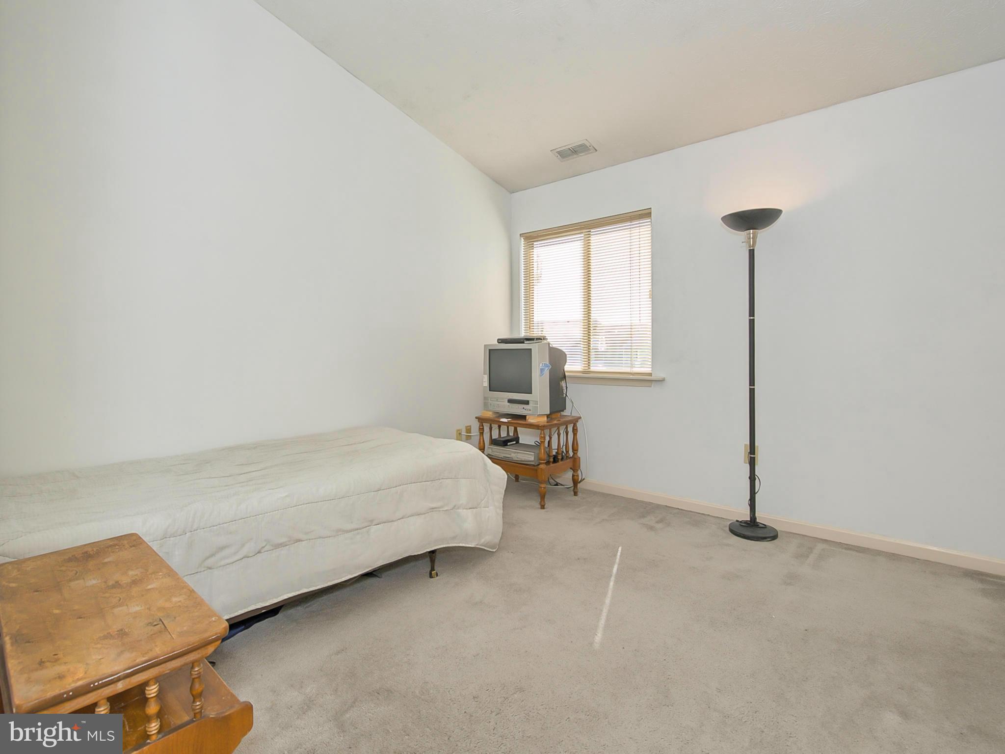 2137 Wainwright Court, Unit 2B Frederick, MD 21702 - Photo 21 of 30 a bed room with a bed and a chair