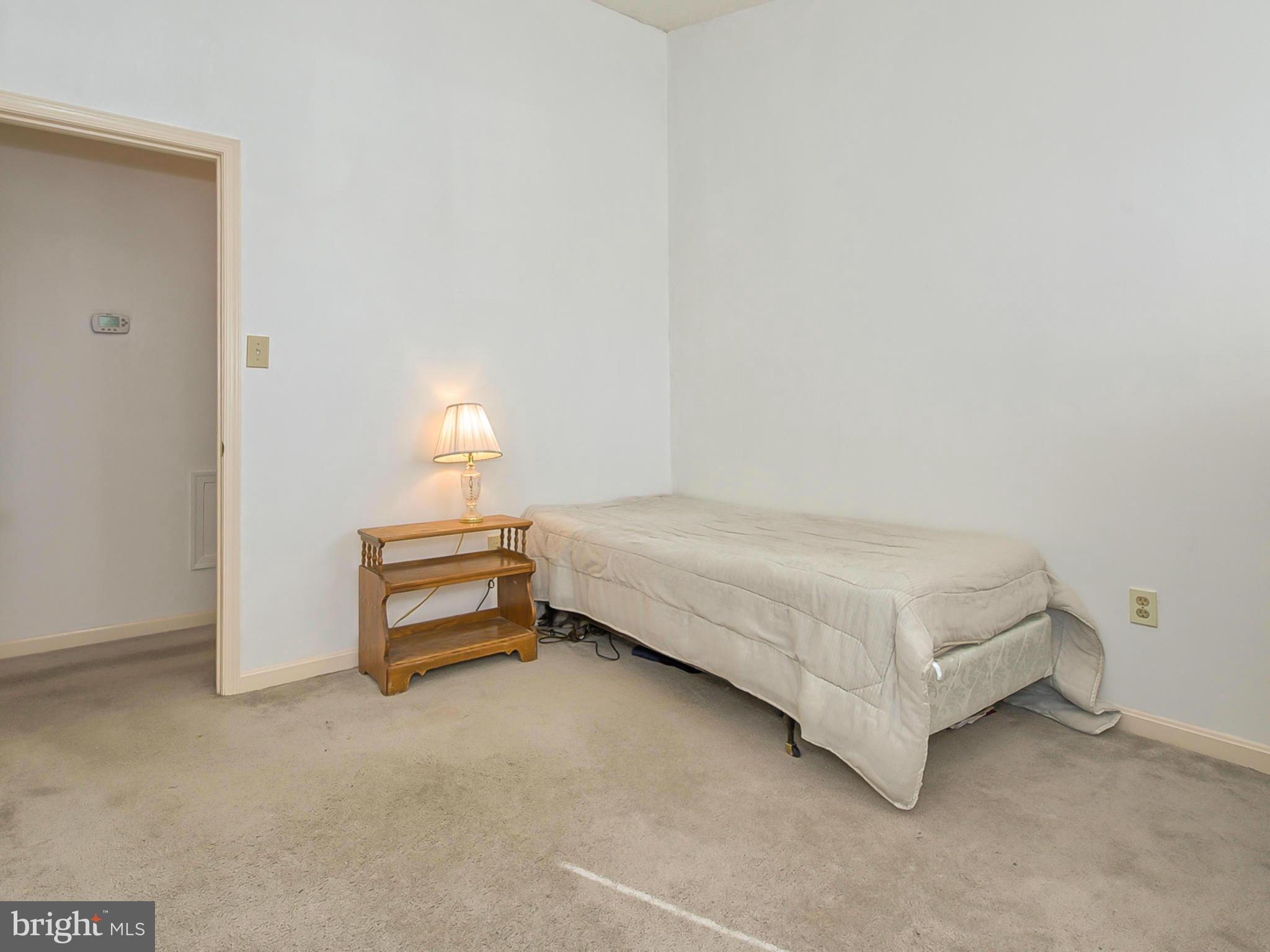 2137 Wainwright Court, Unit 2B Frederick, MD 21702 - Photo 22 of 30 a bedroom with a bed and a table