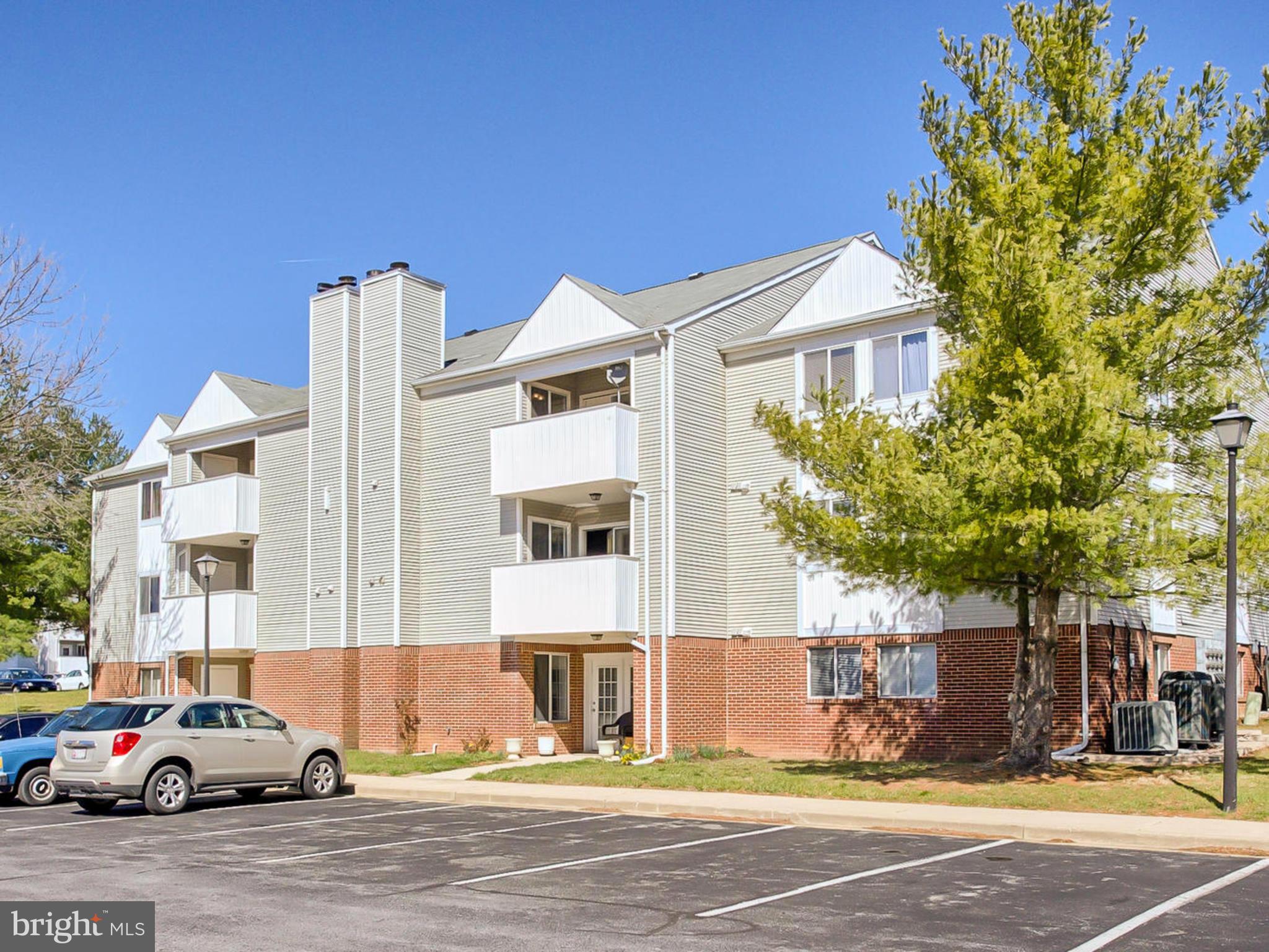 2137 Wainwright Court, Unit 2B Frederick, MD 21702 - Photo 4 of 30 a building that has a tree in front of it