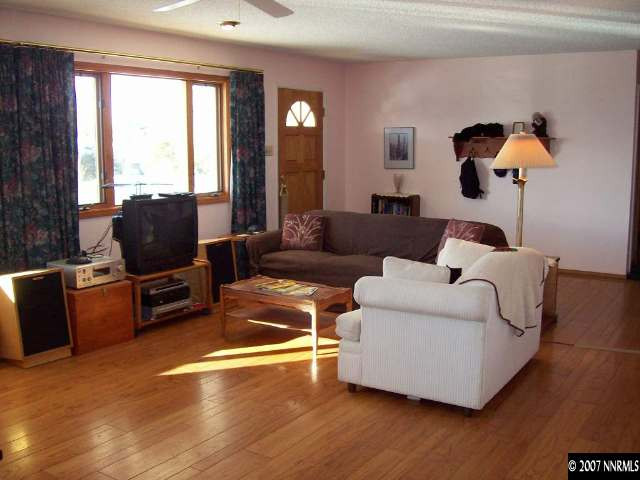 14580 Chamy Drive Reno, NV 89521 - Photo 3 of 9 a living room with furniture and a flat screen tv