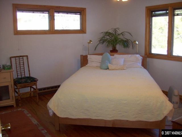 14580 Chamy Drive Reno, NV 89521 - Photo 6 of 9 a bed sitting in a bedroom next to a window