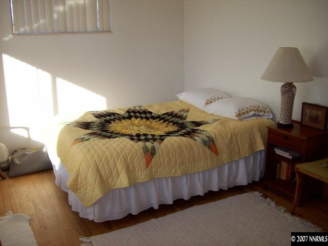 14580 Chamy Drive Reno, NV 89521 - Photo 7 of 9 a bedroom with a bed and a window