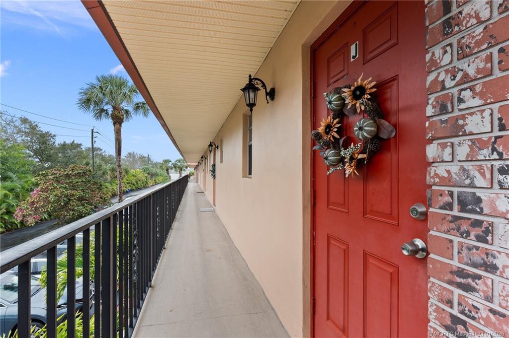 1980 Southwest Palm City Road, Unit 50J Stuart, FL 34994 - Photo 3 of 37 a view of a balcony with wooden floor and stairs