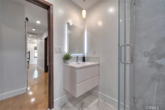 a bathroom with a shower and a sink