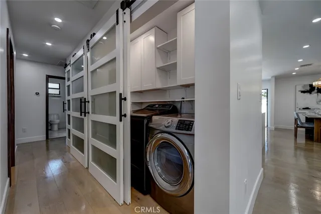 a view of a hallway with washer and dryer