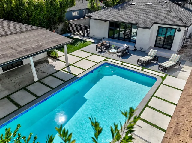swimming pool view with a outdoor seating space