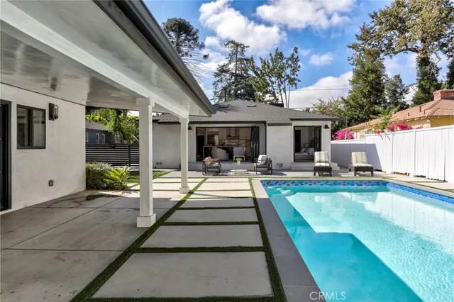 a view of a patio with swimming pool table and chairs