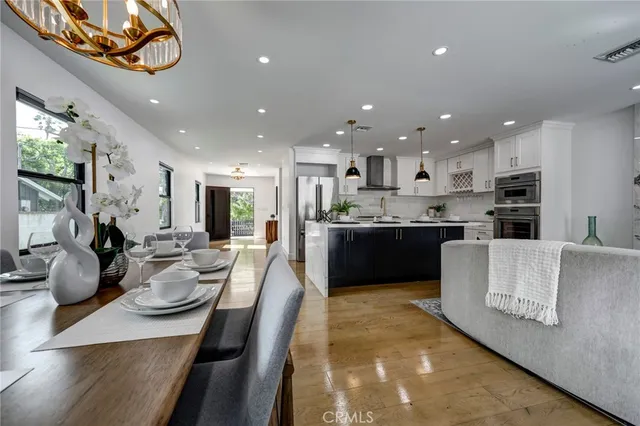 a large kitchen with a table and chairs