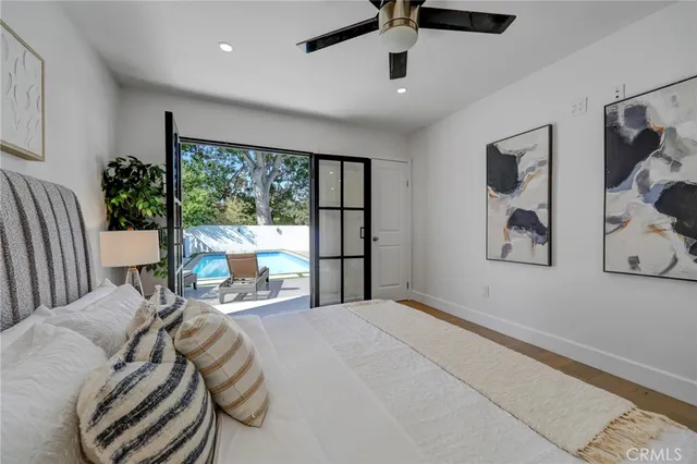 a bedroom with a large bed and a large window