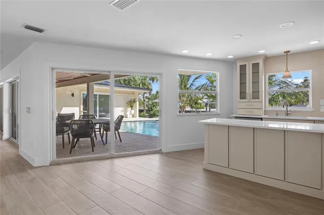 an empty room with windows and cabinet