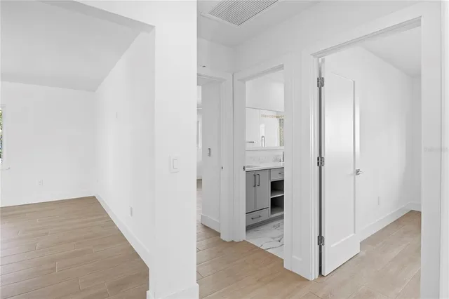 a porch with chairs and potted plants