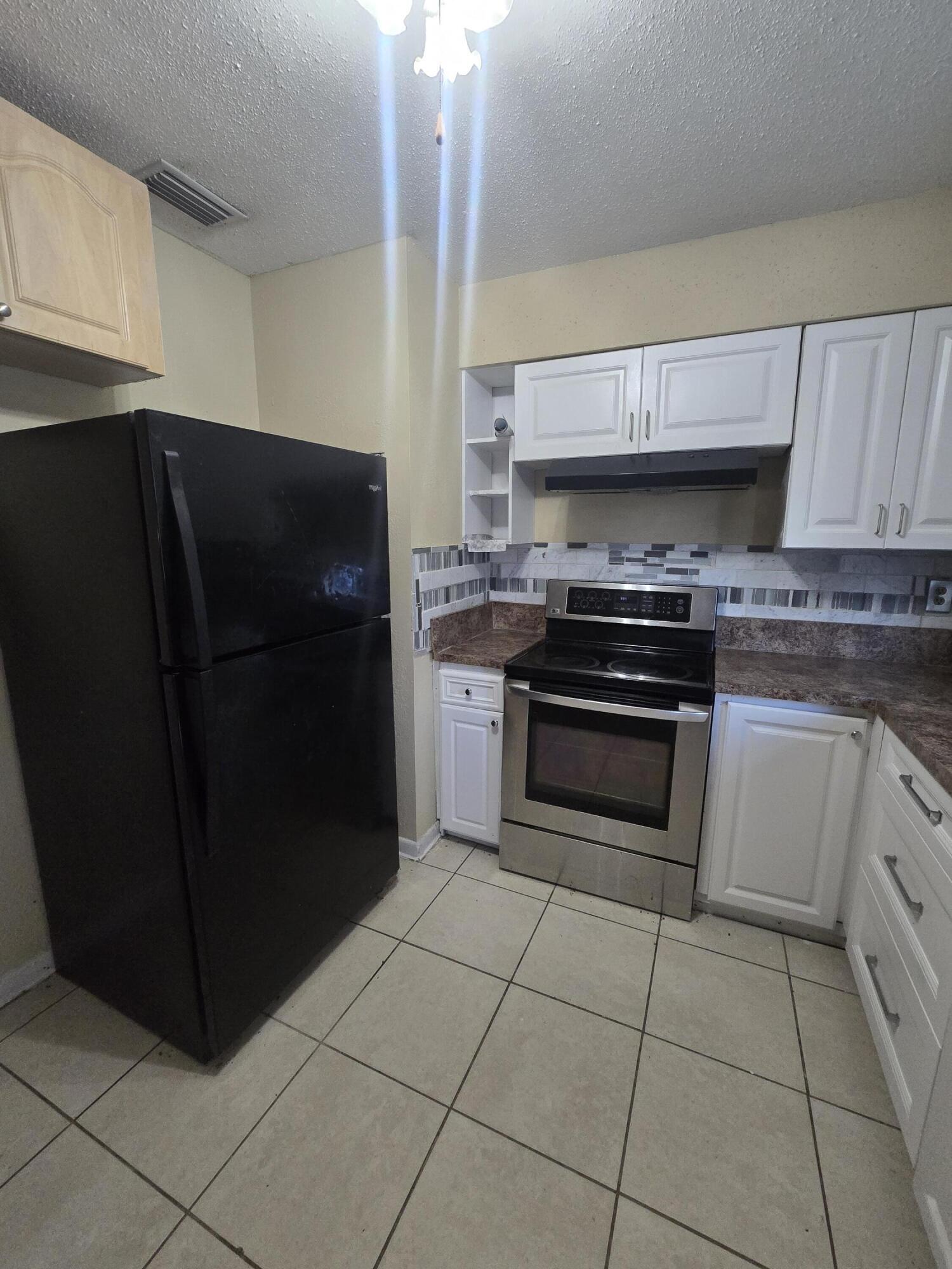 3751 Northwest 36th Street Okeechobee, FL 34972 - Photo 7 of 11 a kitchen with cabinets and steel stainless steel appliances