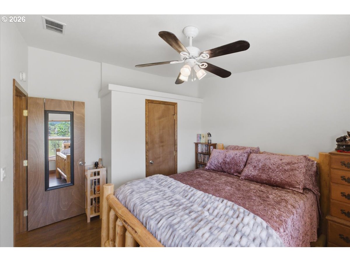 35377 Ede Road Lebanon, OR 97355 - Photo 23 of 48 a bedroom with a large bed and a chandelier