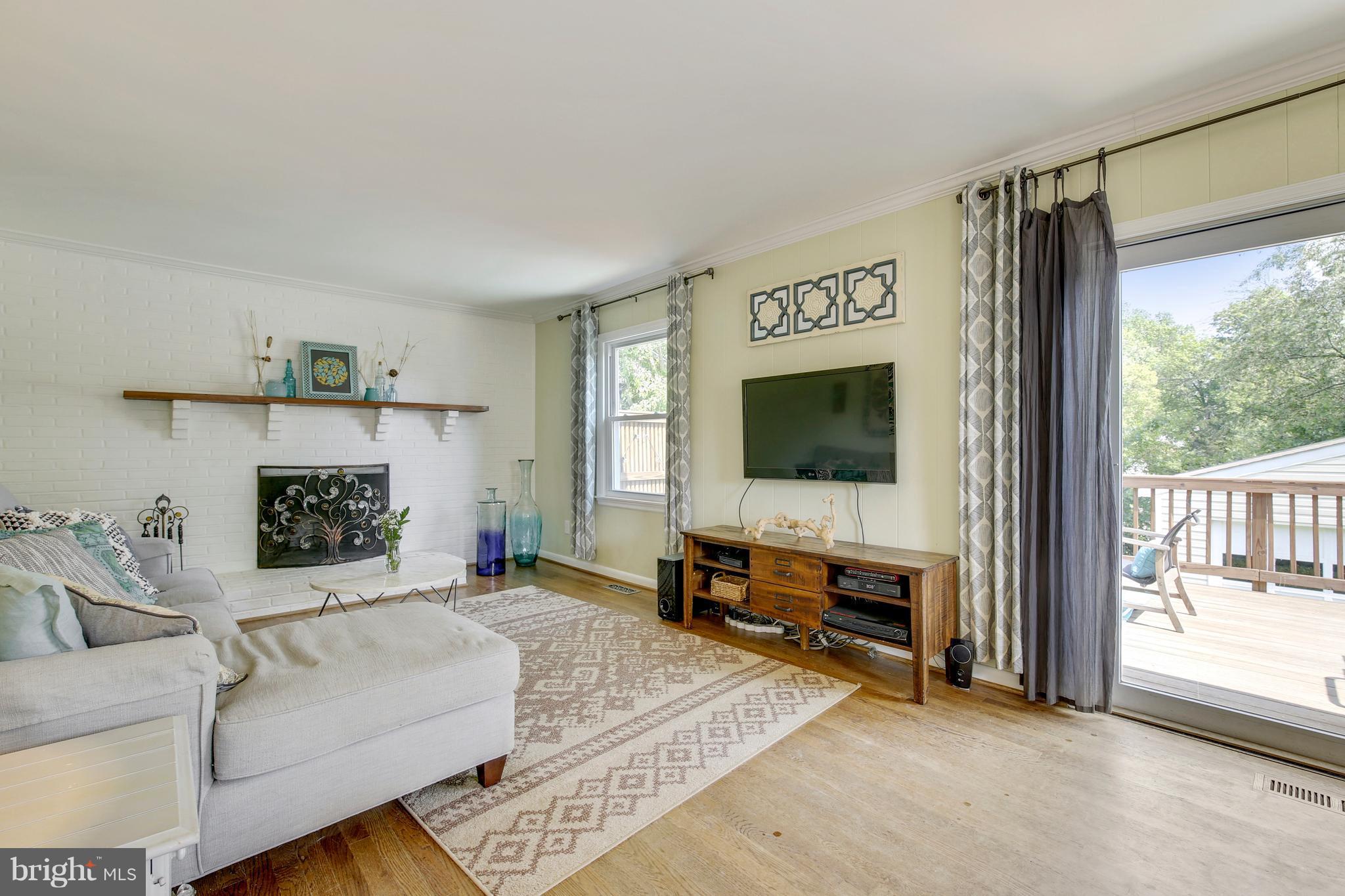 4418 Bennion Road Silver Spring, MD 20906 - Photo 11 of 23 a living room with furniture and a flat screen tv
