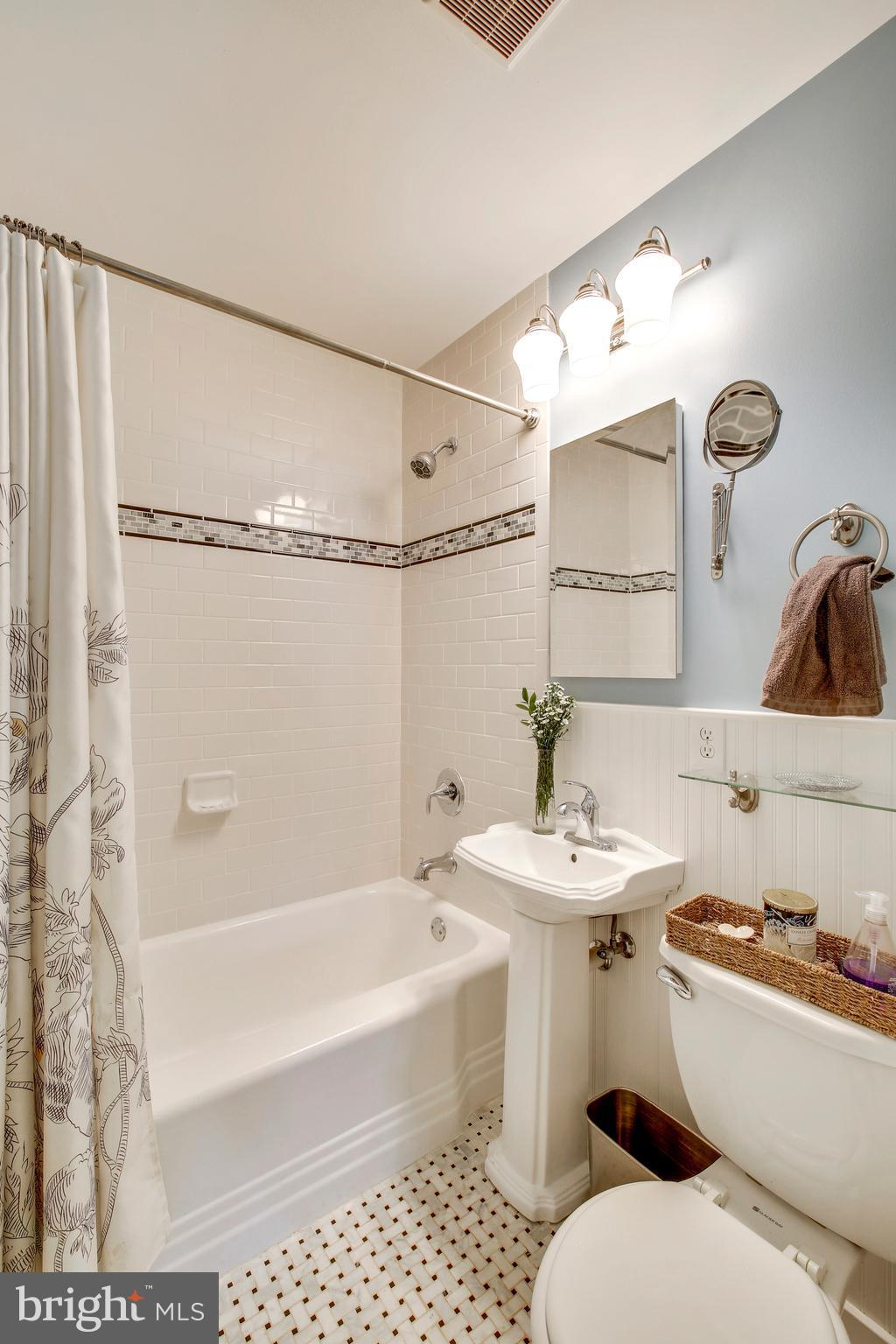 4418 Bennion Road Silver Spring, MD 20906 - Photo 14 of 23 a bathroom with a sink toilet a mirror and shower