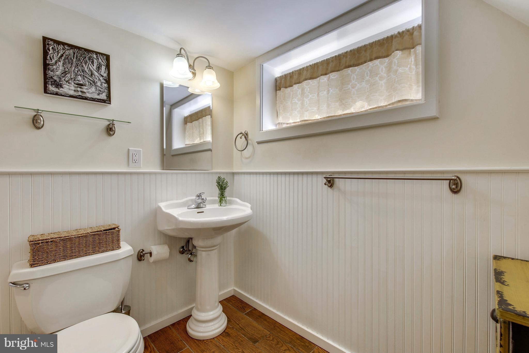 4418 Bennion Road Silver Spring, MD 20906 - Photo 16 of 23 a bathroom with a toilet sink and mirror