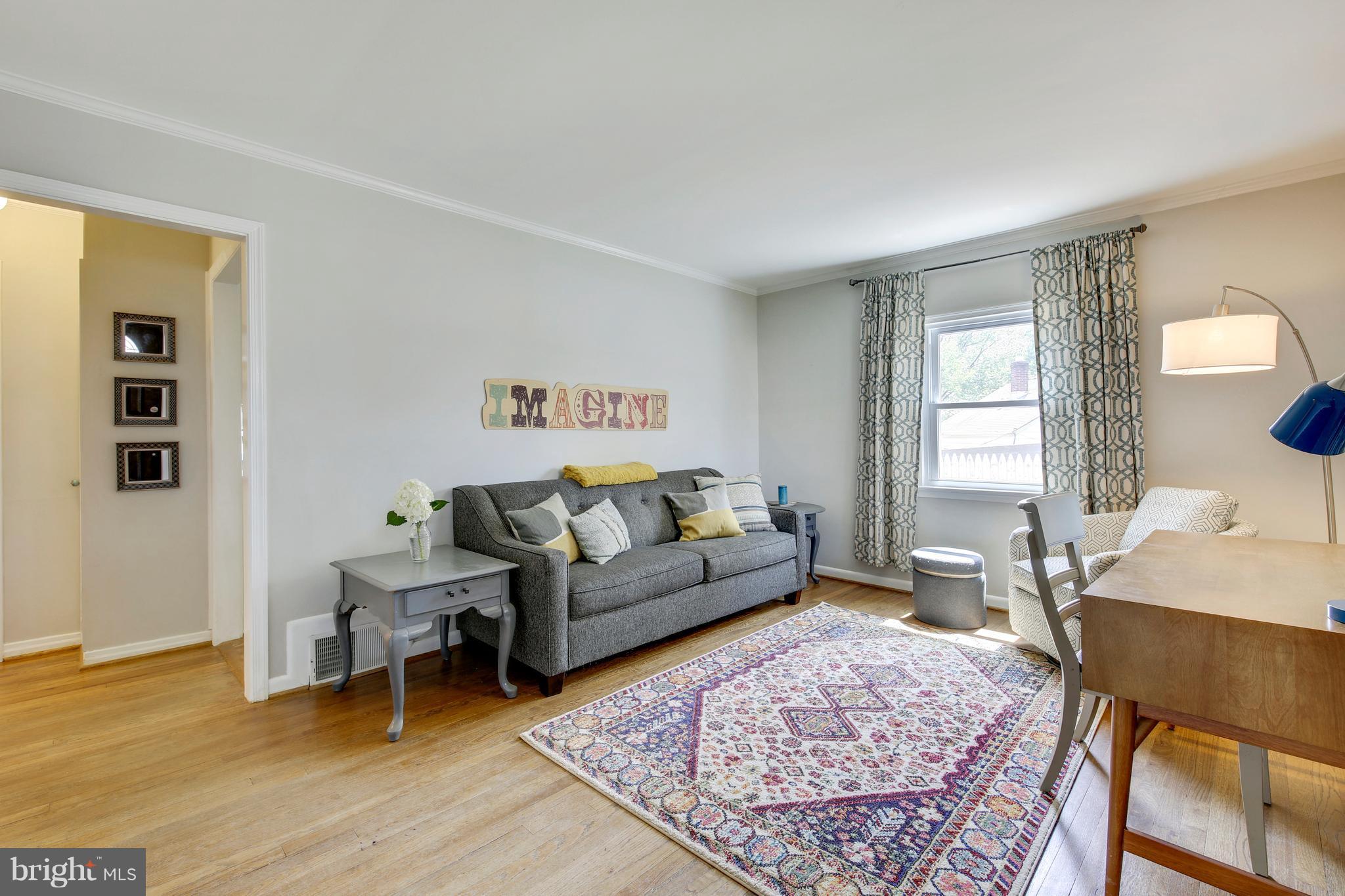 4418 Bennion Road Silver Spring, MD 20906 - Photo 4 of 23 a living room with furniture and a rug