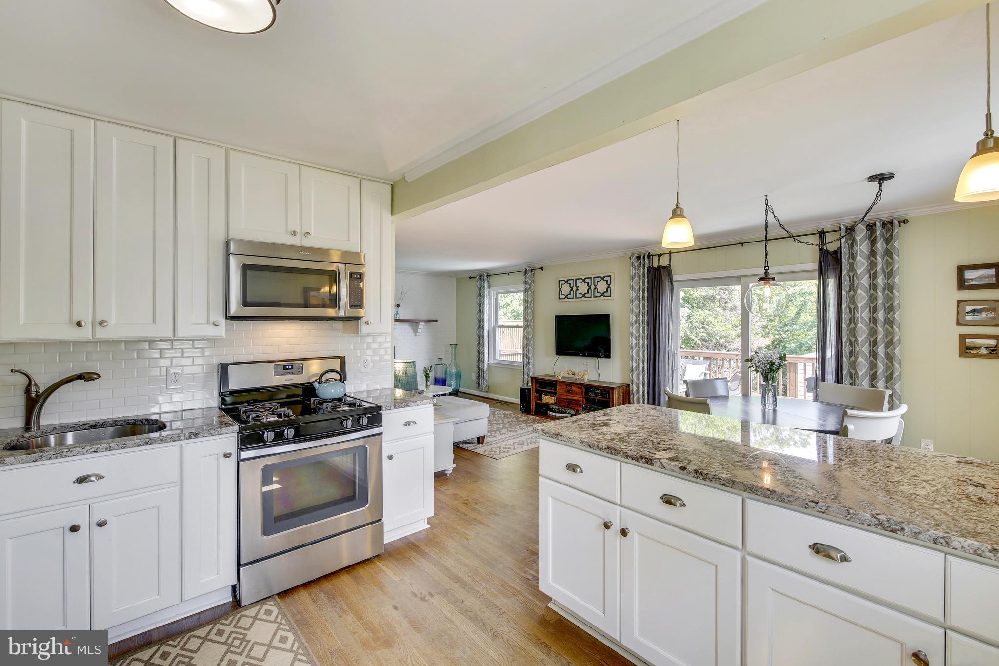 4418 Bennion Road Silver Spring, MD 20906 - Photo 5 of 23 a kitchen with sink a stove and cabinets