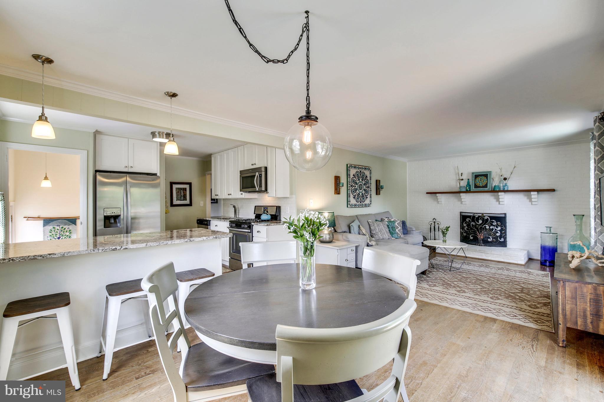 4418 Bennion Road Silver Spring, MD 20906 - Photo 7 of 23 a dining room with furniture wooden floor and a chandelier
