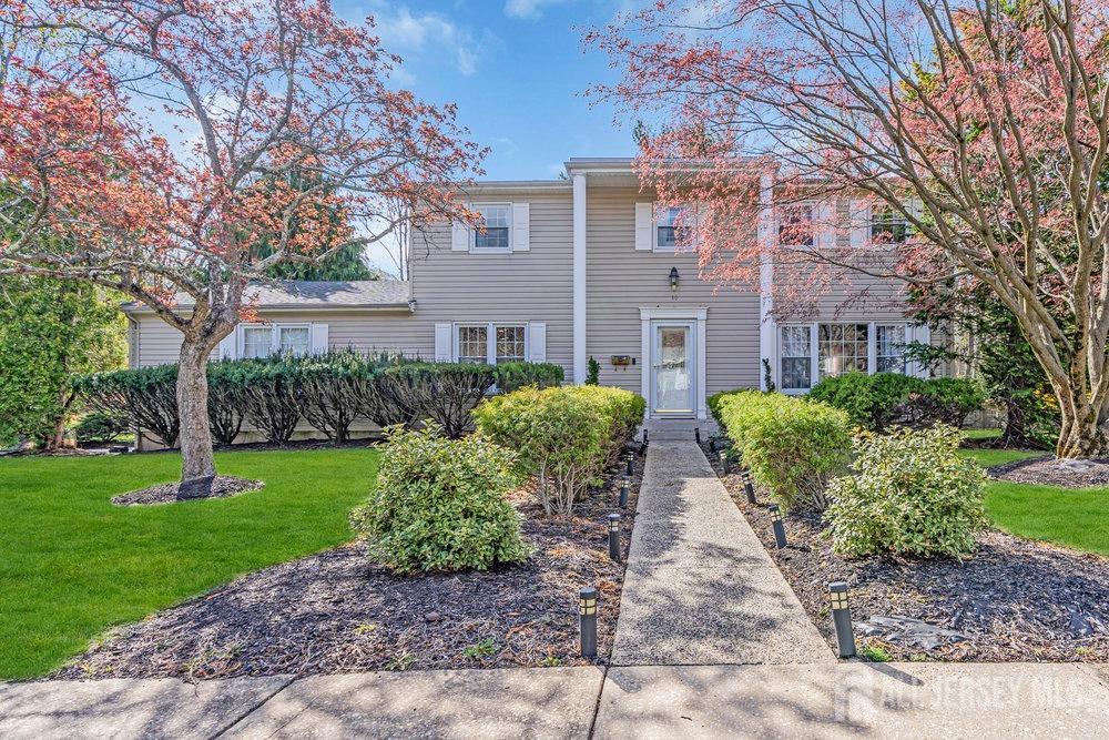 10 Kings Road East Brunswick, NJ 08816 - Photo 1 of 33 a view of a brick house with a yard and large trees