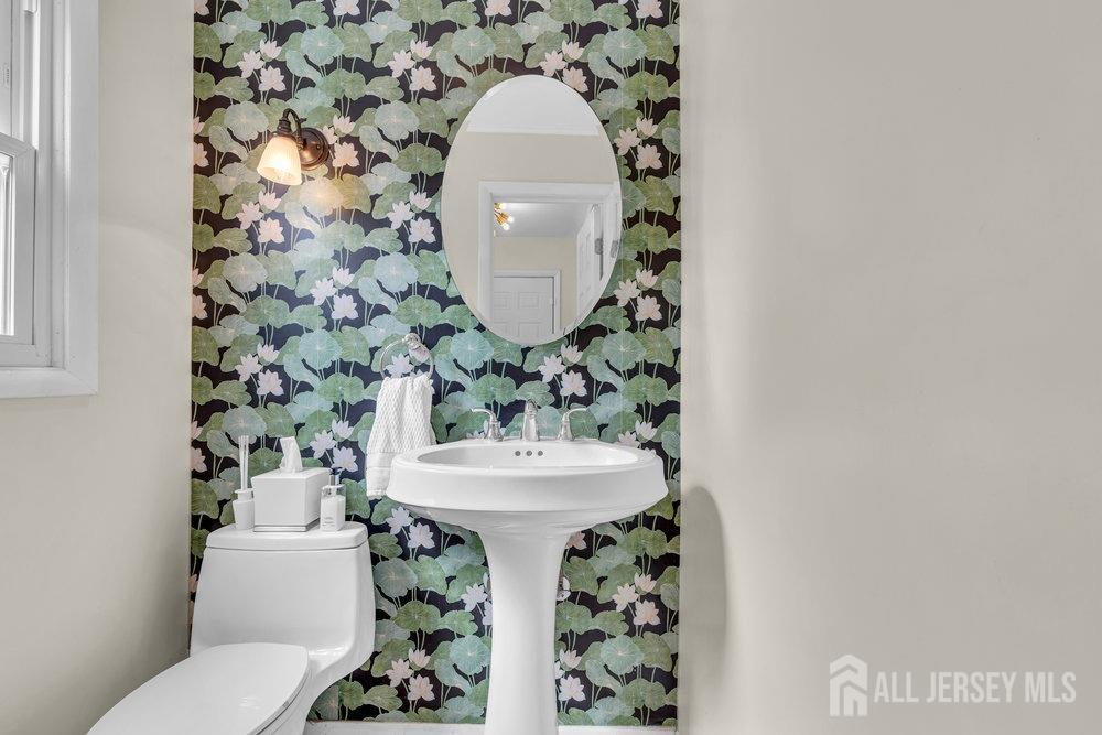 10 Kings Road East Brunswick, NJ 08816 - Photo 15 of 33 a bathroom with a sink a mirror and toilet