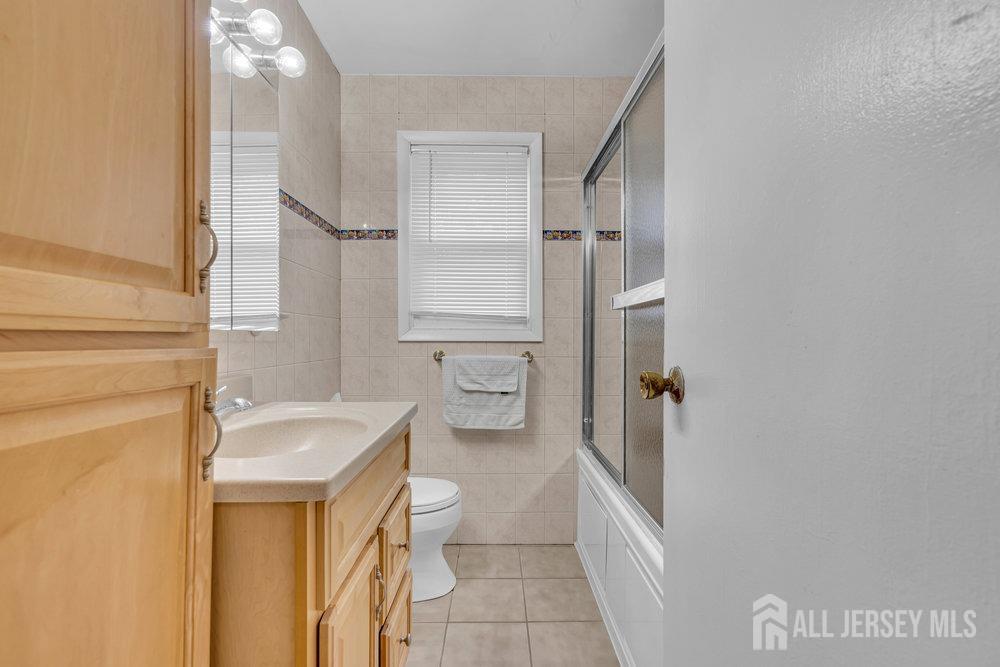 10 Kings Road East Brunswick, NJ 08816 - Photo 17 of 33 a bathroom with a granite countertop sink toilet and shower