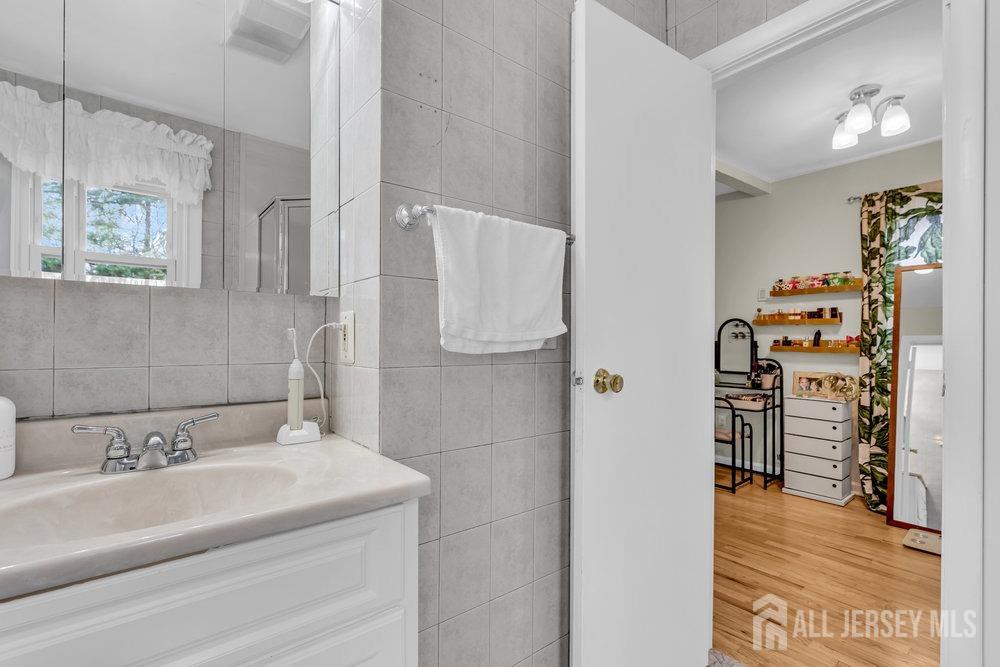 10 Kings Road East Brunswick, NJ 08816 - Photo 21 of 33 a bathroom with a sink and a shower