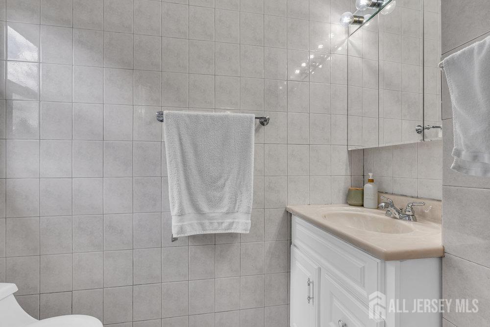 10 Kings Road East Brunswick, NJ 08816 - Photo 22 of 33 a bathroom with a sink shower and a mirror