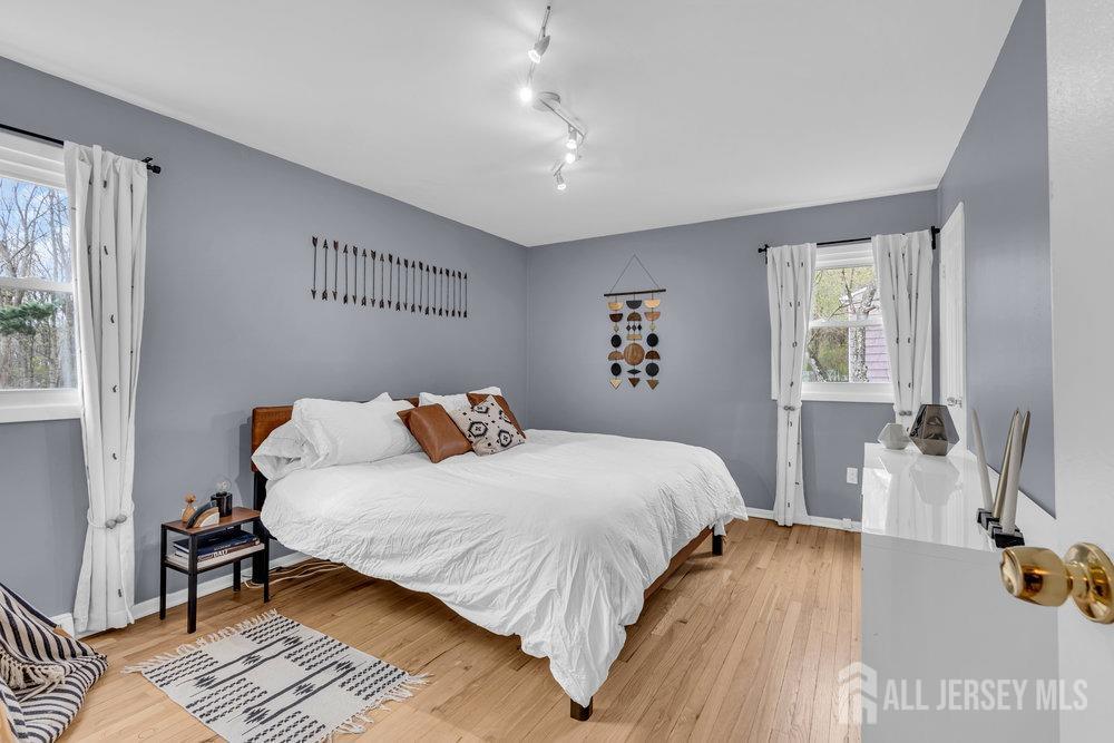 10 Kings Road East Brunswick, NJ 08816 - Photo 23 of 33 a bedroom with a bed and wooden floor