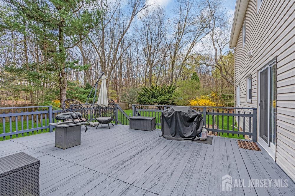10 Kings Road East Brunswick, NJ 08816 - Photo 28 of 33 a view of a deck with table and chairs and wooden floor